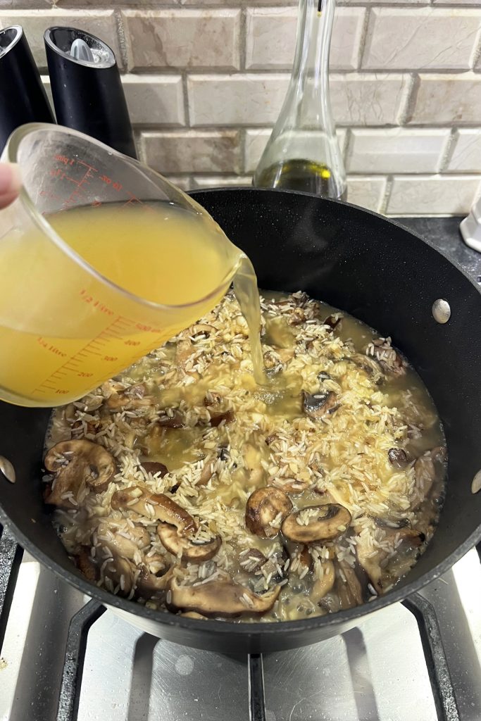Pour chicken broth into the skillet.