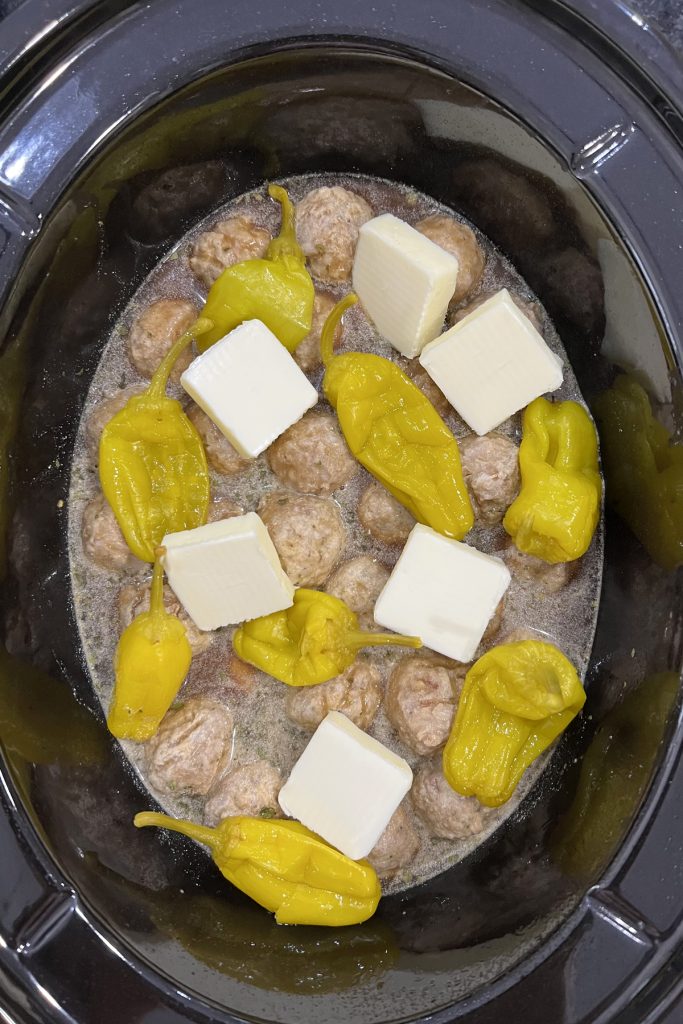Top with pats of butter and peppers.