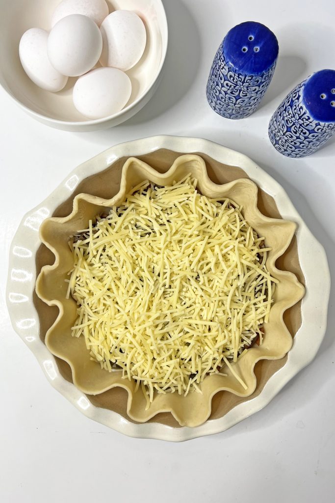 Top with shredded gruyere.