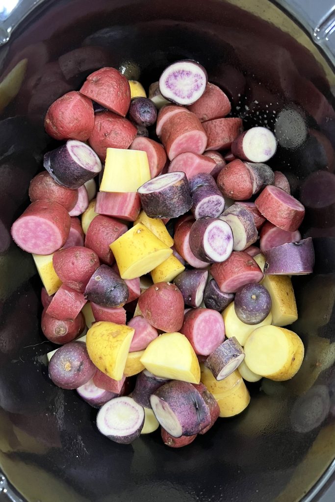 Place cut potatoes into the crockpot.