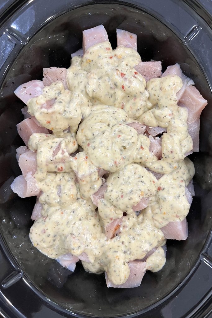 Pour garlic parmesan sauce on top of the chicken.