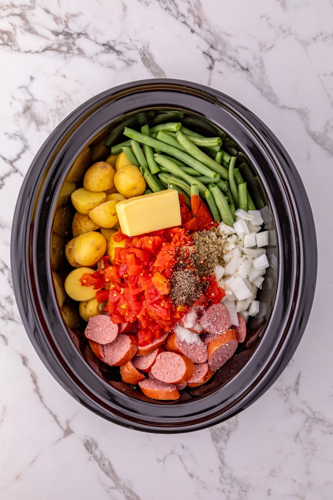 Slow Cooker Sausage and Potatoes ingredients in a crockpot