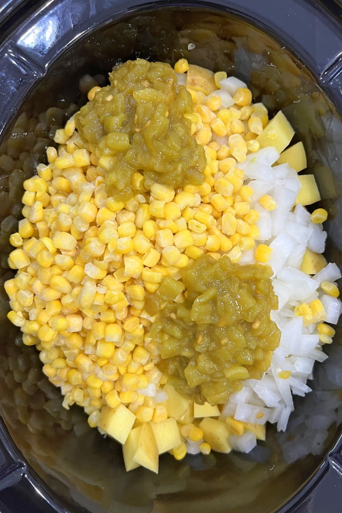 Add potatoes, corn, onions, and green chilies.