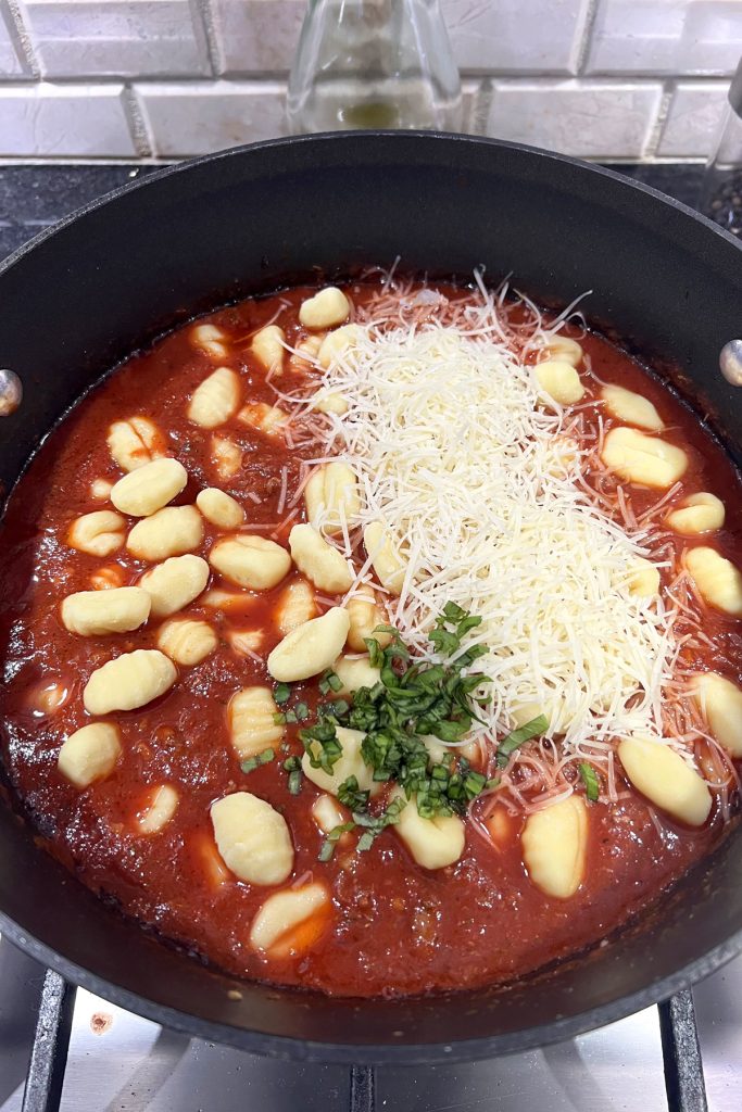 Add gnocchi, parmesan cheese, and fresh basil.
