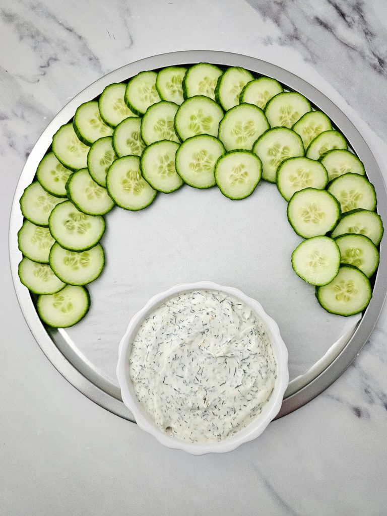 sliced cucumbers around the top half of a circular tray