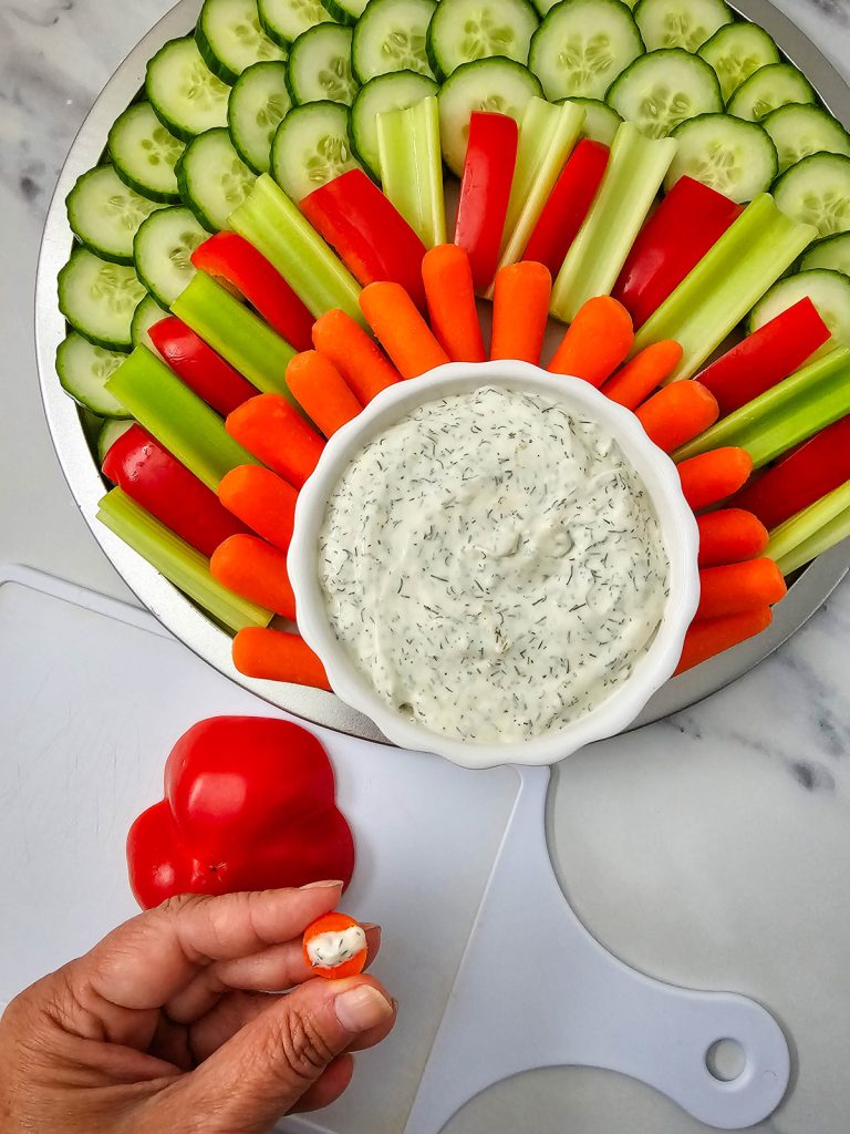 attach carrot nose with some of the dip