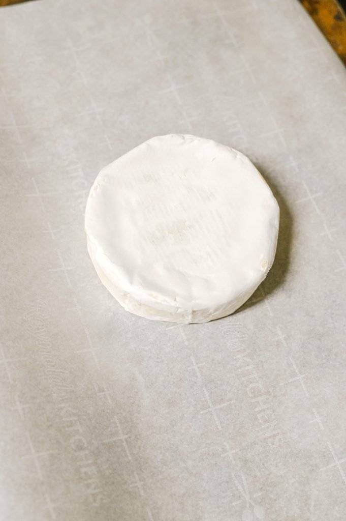 Unwrap brie and place on parchment paper.