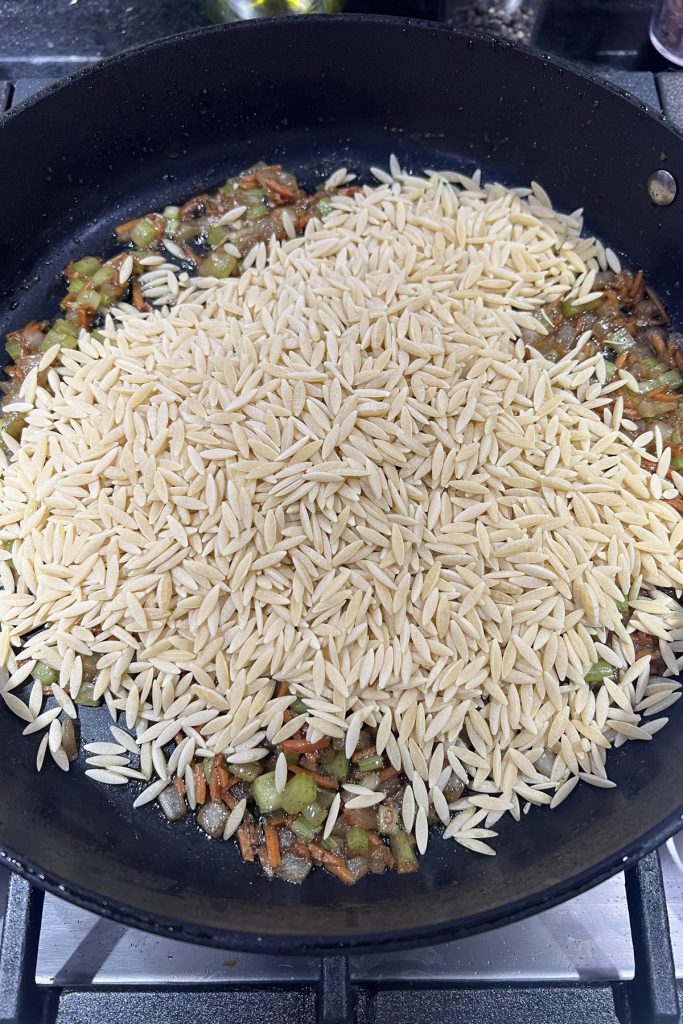 Add orzo to the skillet