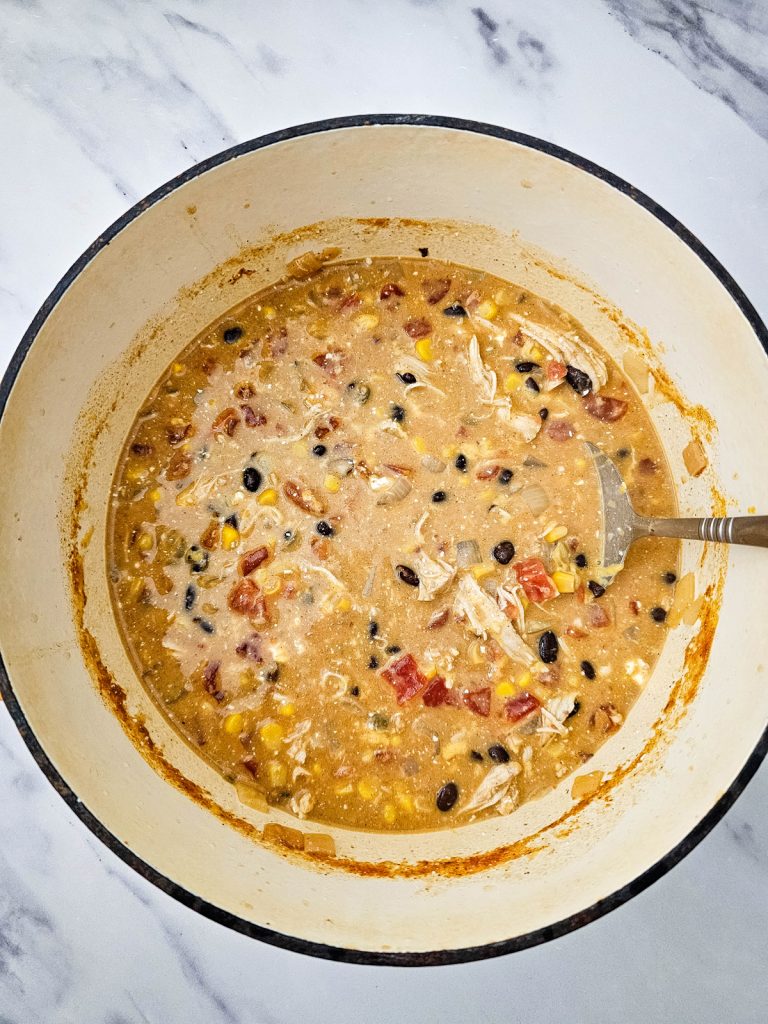 Chicken enchilada soup in a Dutch oven.