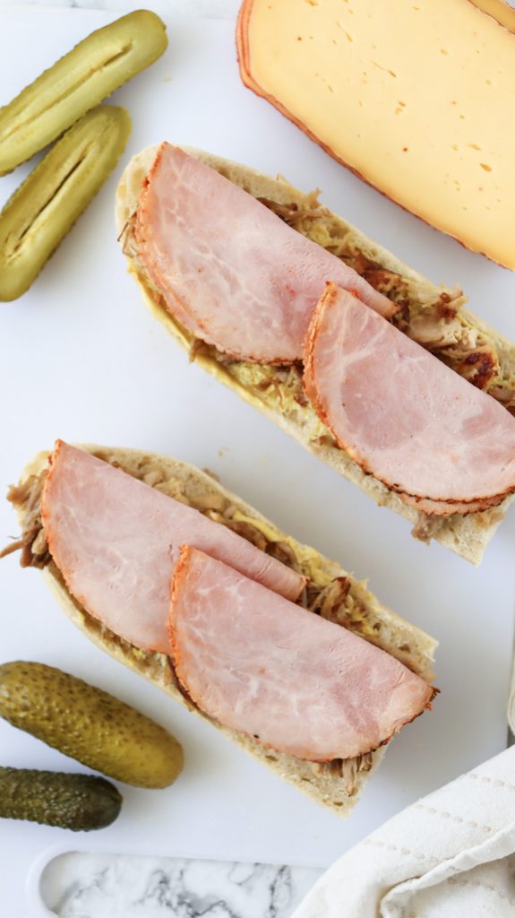 Ham slices and pulled pork on sliced bread.