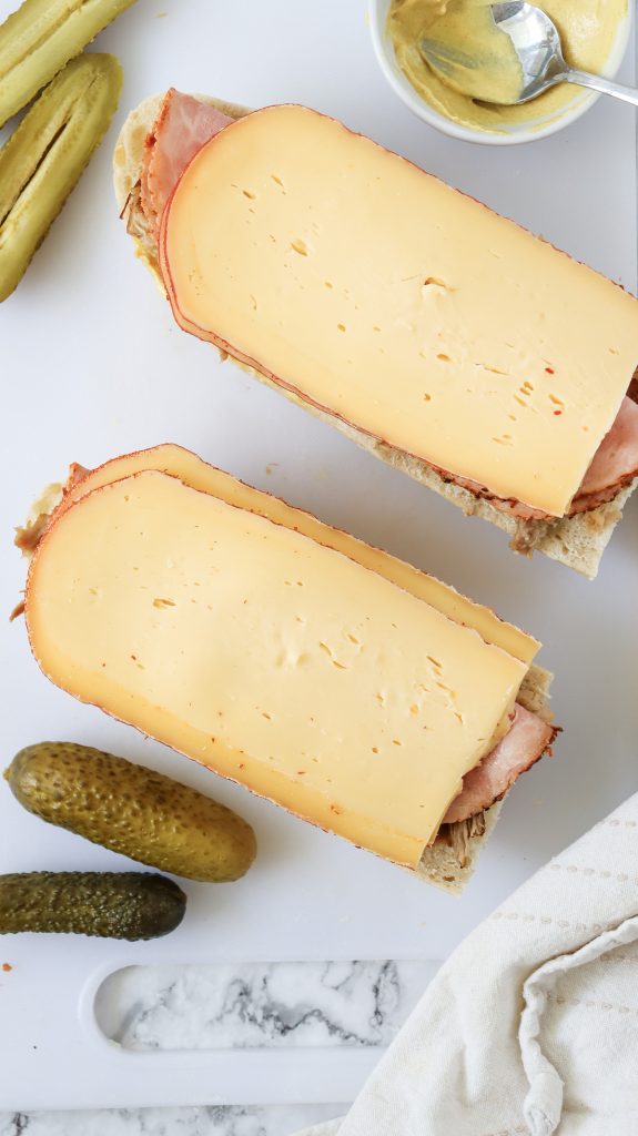 Swiss cheese, ham, and pulled pork on sandwich bread