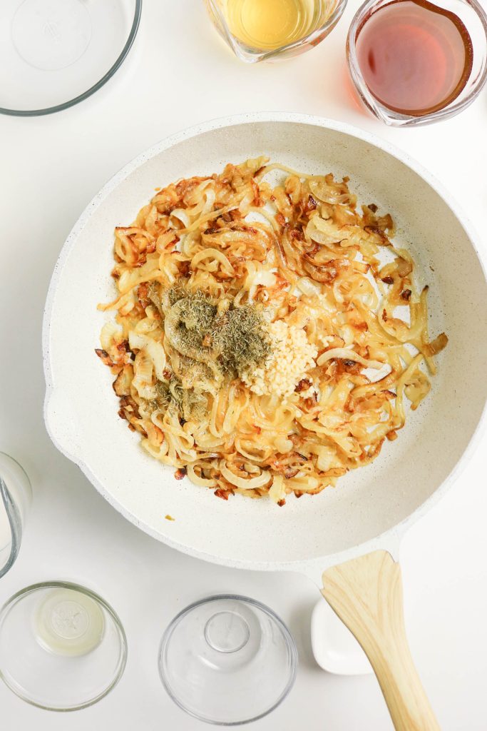Sauteed onions and seasonings in a skillet.