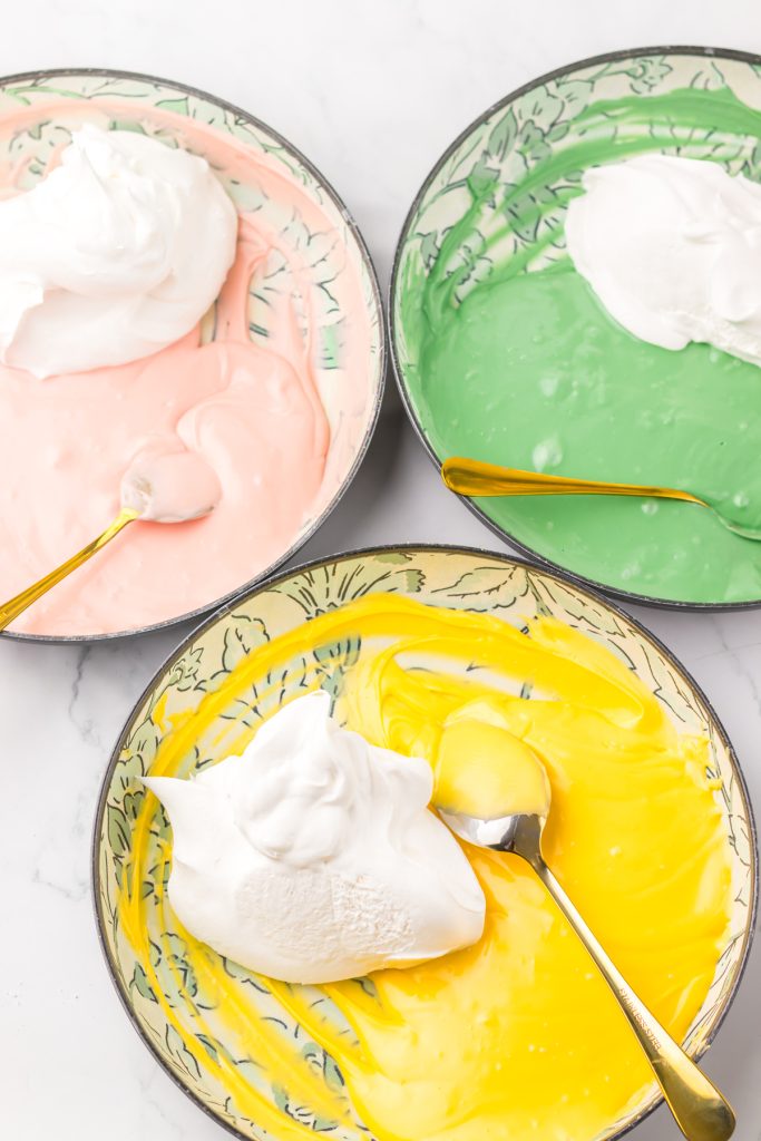 Green, pink, and yellow candy melts mixed with whipped topping.
