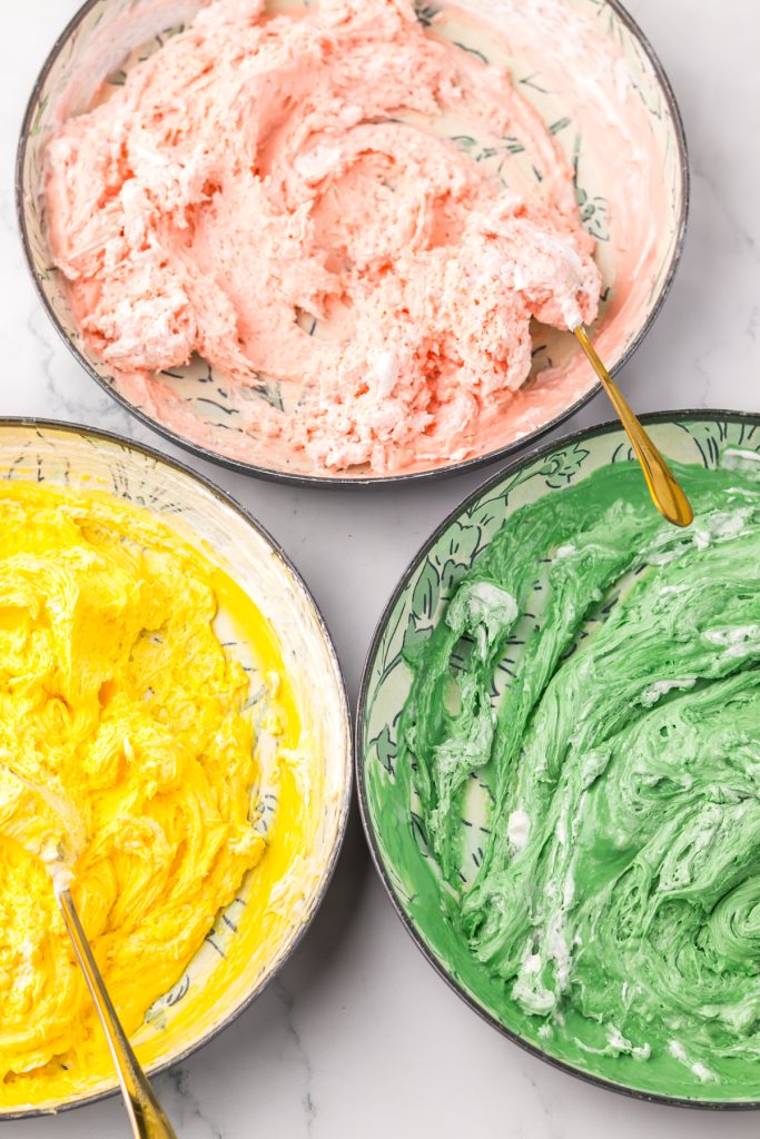 Green, pink, and yellow candy melts mixed with whipped topping.