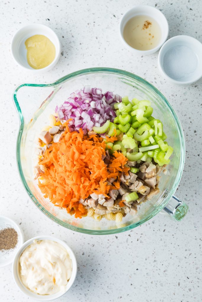 Add chopped chicken and veggies into a bowl.