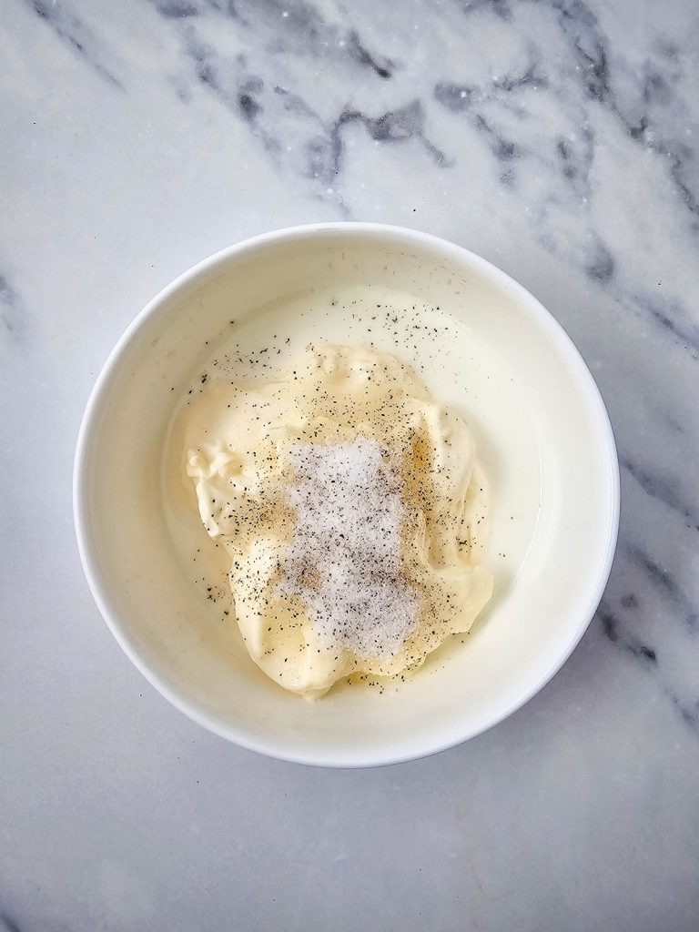 Mayonnaise, milk, and seasonings in a small bowl.