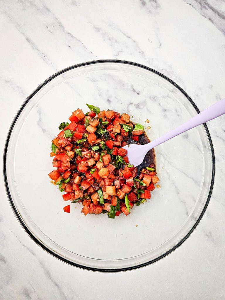 Bruschetta tomato mixture in a glass bowl.