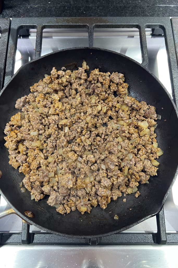 Seasoned ground beef in a skillet.