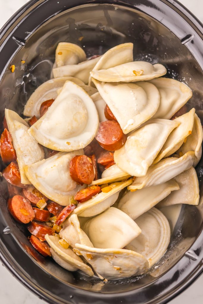 Pierogies and browned sausage in a crockpot..