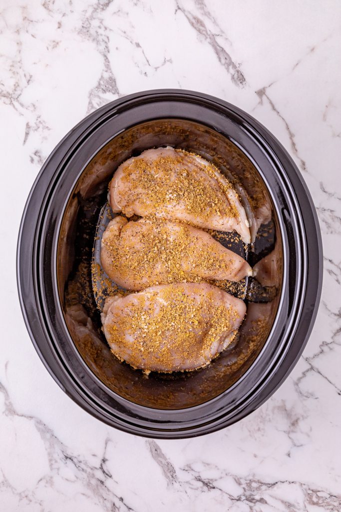 Place chicken in crockpot and add seasonings.