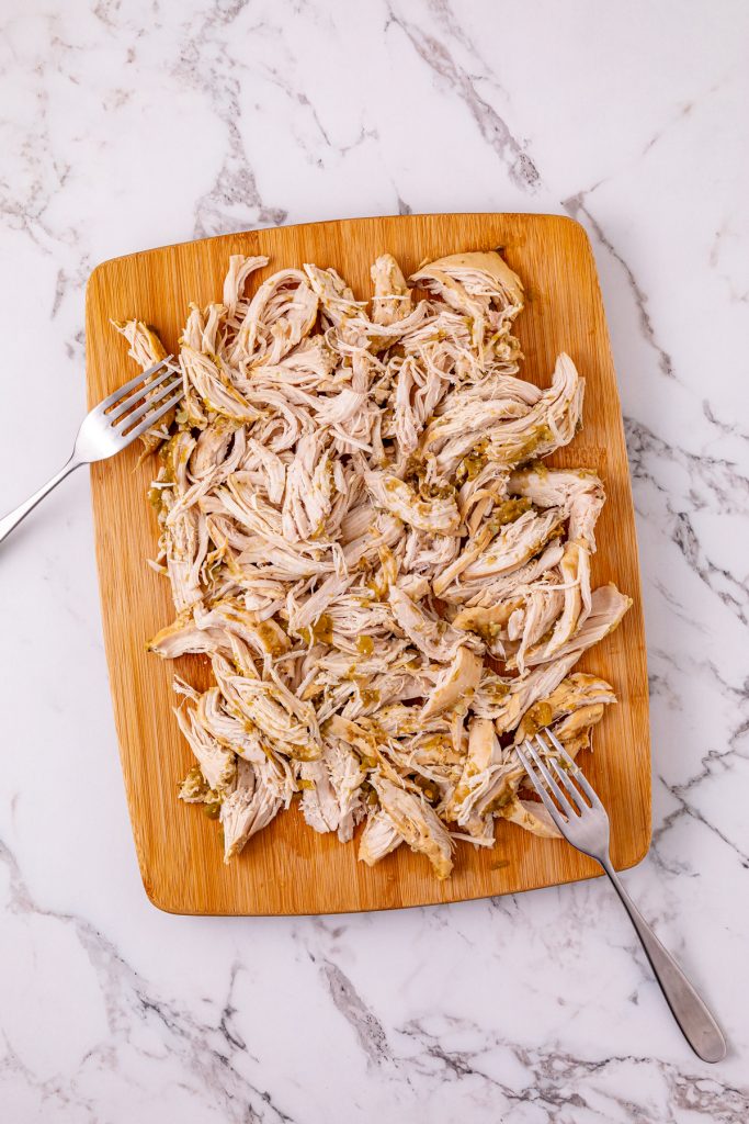 Remove the chicken from the slow cooker and shred with 2 forks.