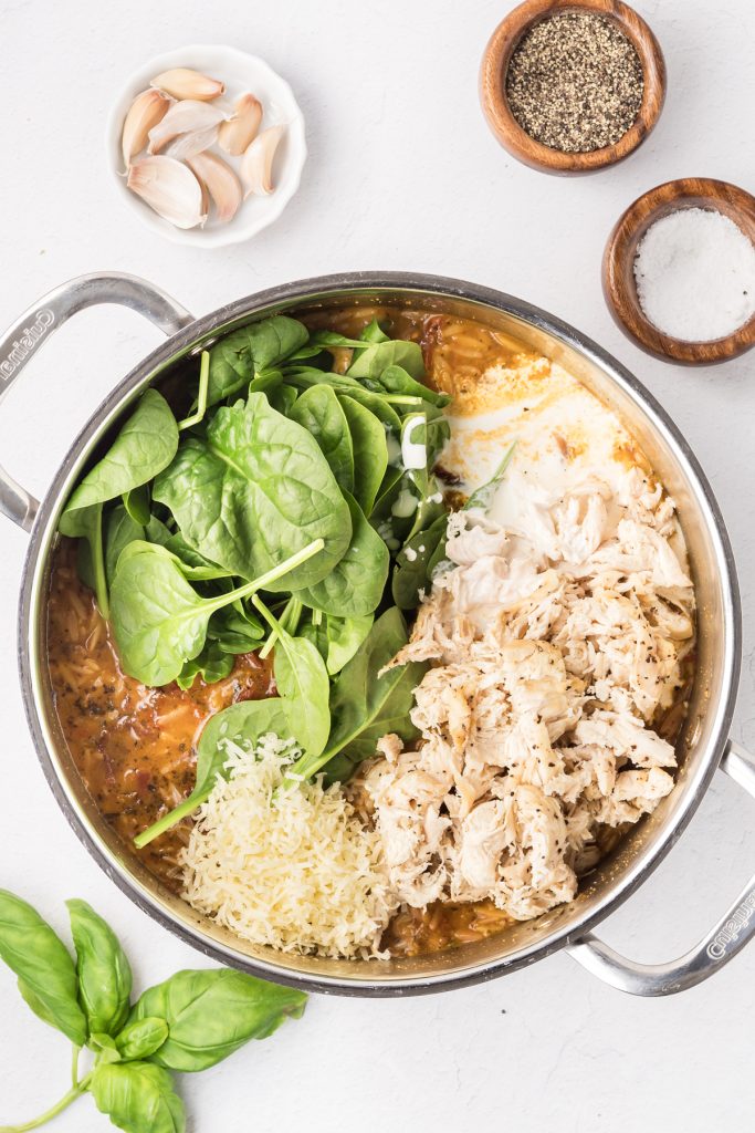 Spinach, shredded chicken, and parmesan cheese mixed into cooked orzo.